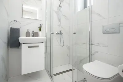 a white bathroom with a shower and a toilet at Villa Queen Valentina in Protaras