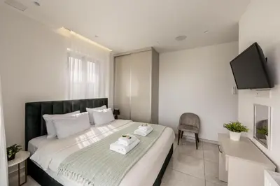 a bedroom with a large bed with towels on it at Green Heaven Villa 3 in Protaras