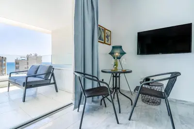 a living room with a table and chairs and a tv at Oyster 1-BR Apt in Larnaca in Larnaka