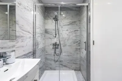 a bathroom with a shower with a glass door at Oyster 1-BR Apt in Larnaca in Larnaka