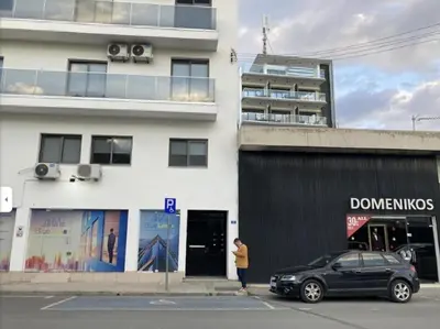 a woman standing in front of a building at Happy Homes Paradise in Larnaka