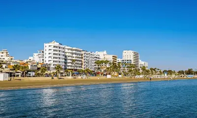 a view of a beach with buildings in the background at Happy Homes Paradise in Larnaka