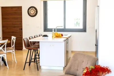 a kitchen with a counter and a table and chairs at Protaras Sol e Mar Villa 1 in Protaras