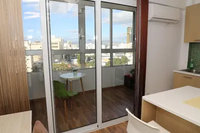 a kitchen with a balcony with a view of a city at Achillion Apartments By 'Flats Nicosia' in Nicosia