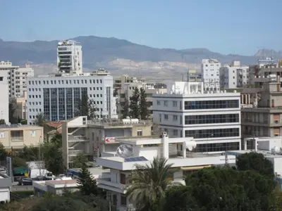 a city skyline with buildings and mountains in the background at Achillion Apartments By 'Flats Nicosia' in Nicosia