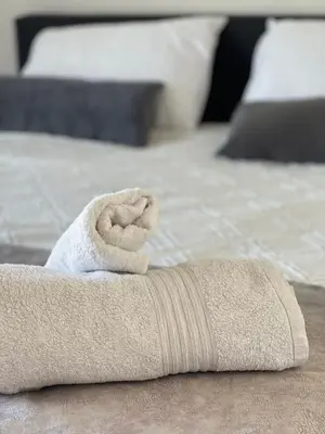 a rolled up towel sitting on top of a bed at Cielo Apartment No2 in Ayia Napa