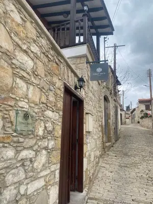 a stone building with a door on a street at VINGT-DEUX Vouni 22 in Vouni