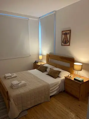 a bedroom with a large bed with two lamps on it at Demetra 1 Bdr Down Town Nicosia in Nicosia