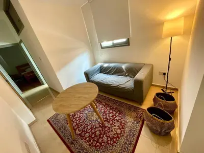 a small living room with a couch and a table at Demetra 1 Bdr Down Town Nicosia in Nicosia