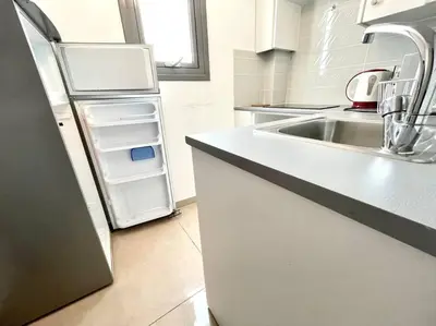 a kitchen with a sink and a refrigerator at Demetra 1 Bdr Down Town Nicosia in Nicosia