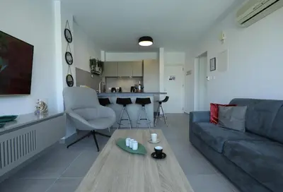 a living room with a couch and a table at Lovely cozy one bedroom suite with pool in Protaras