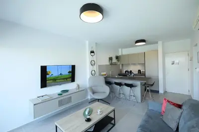 a living room with a couch and a table at Lovely cozy one bedroom suite with pool in Protaras
