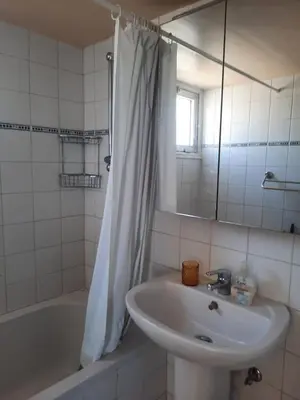 a bathroom with a sink and a tub and a mirror at Seascape 501 in Larnaka