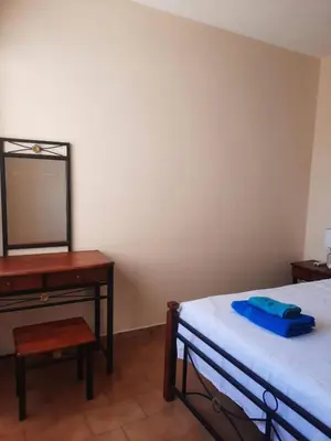 a bedroom with a bed and a dresser and a mirror at Seascape 501 in Larnaka