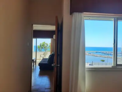 a room with a view of the ocean from a door at Seascape 501 in Larnaka