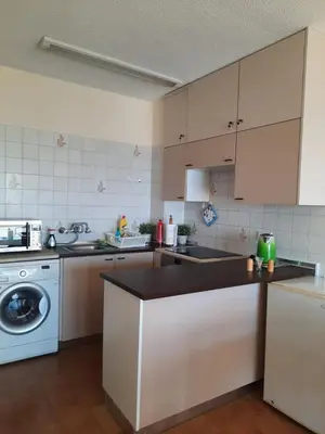 a kitchen with white cabinets and a dishwasher at Seascape 501 in Larnaka