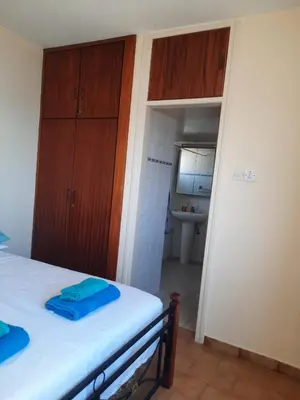 a small room with a bed and a bathroom at Seascape 501 in Larnaka