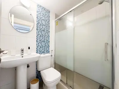 a bathroom with a toilet and a sink and a mirror at Sherpa Apartments in Ayia Napa