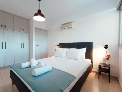 a bedroom with a bed with towels on it at The Chalk in Larnaka