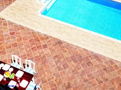 an overhead view of a table and chairs next to a swimming pool at Villa Grand Zeus in Anoyira