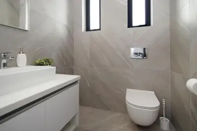 a bathroom with a white toilet and a sink at Villa Queen Eleanor in Protaras