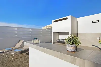 a balcony of a house with a table and chairs at Villa Queen Helena in Protaras