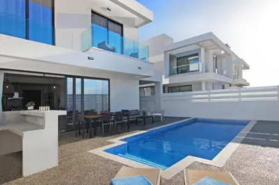 a house with a swimming pool in front of it at Villa Queen Helena in Protaras