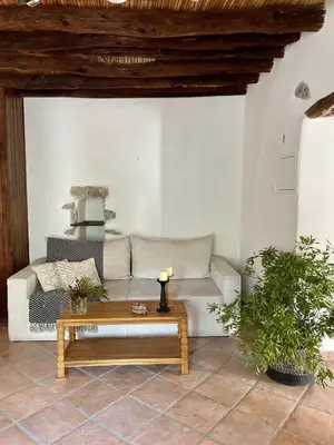 a living room with a couch and a coffee table at Stone built country house in Louvaras Village in Louvaras