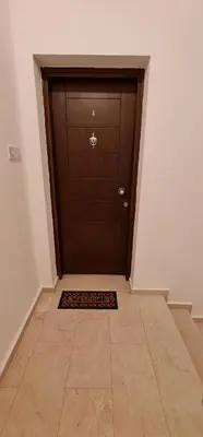a large wooden door with a mat in front of it at Oytam apt in Nicosia