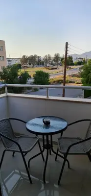 a table and chairs on a balcony with a view of a street at Oytam apt in Nicosia
