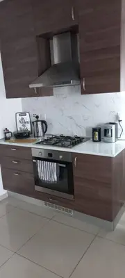 a kitchen with a stove top oven in a kitchen at Oytam apt in Nicosia