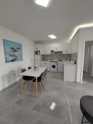 a kitchen with a table and chairs in a room at Amazing Napa Apartment in Ayia Napa