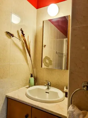 a bathroom with a sink and a mirror at Dock Holiday Apartment in Larnaka
