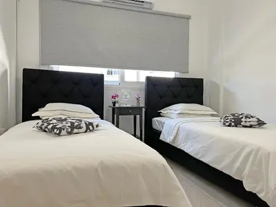 two beds sitting next to each other in a bedroom at Albert's apartment Marina 15 in Larnaka