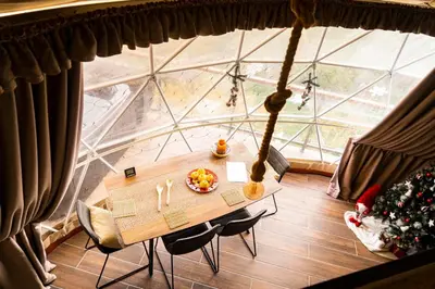 a table in a room with a large window at Agros Glamping Boutique in Agros