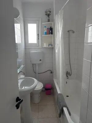 a bathroom with a sink and a toilet and a shower at Ptolemaidos cosy Family apartment in Larnaka