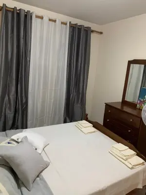 a bedroom with a bed with a mirror and a dresser at Ptolemaidos cosy Family apartment in Larnaka