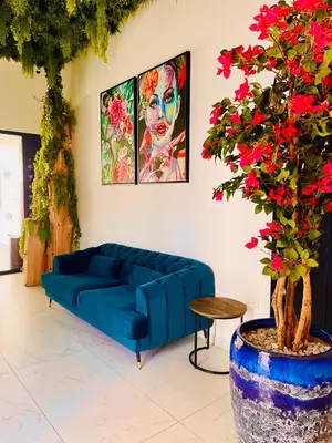 a blue couch in a living room with a tree at Sveltos Residence Suites in Larnaka