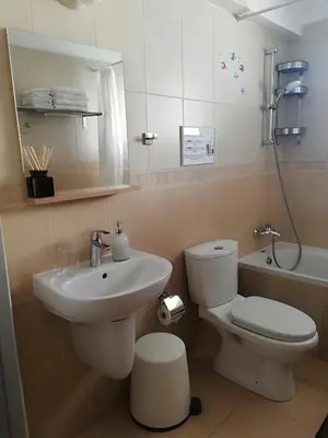 a bathroom with a sink and a toilet and a tub at Yiasemi Ground floor Holiday Appartment in Paralimni