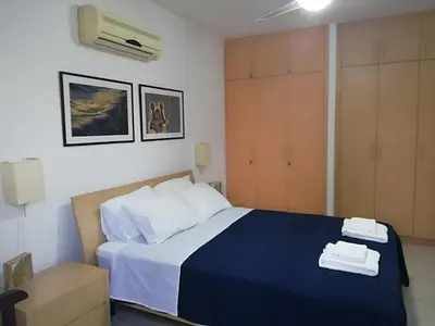 a bedroom with a bed with two towels on it at Yiasemi Ground floor Holiday Appartment in Paralimni
