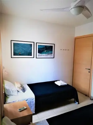 a bedroom with a bed and two pictures on the wall at Yiasemi Ground floor Holiday Appartment in Paralimni