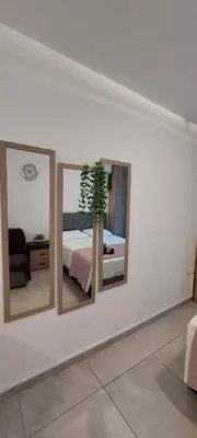 a bedroom with three mirrors on a wall with a bed at Stay With Oleg C17 in Paralimni