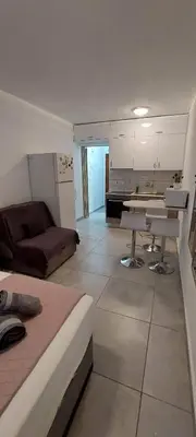 a living room with a bed and a kitchen at Stay With Oleg C17 in Paralimni
