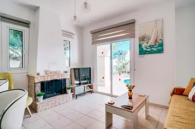 a living room with a couch and a fireplace at Villa Pant Poly in Protaras