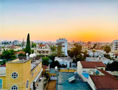 a view of a city at sunset at The Penthouse 401 in Larnaka