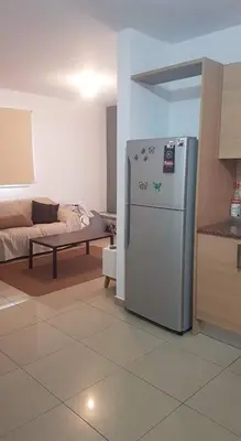 a kitchen with a refrigerator in the middle of a room at Andris apartment in Paralimni