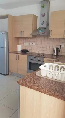 a kitchen with a counter top with baskets on it at Andris apartment in Paralimni