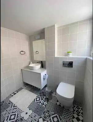 a bathroom with a white toilet and a sink at 2 bedroom apt in Ermou 4 minute walk beach in Larnaka