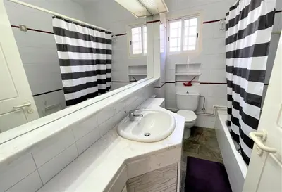 a white bathroom with a sink and a toilet at Blossom Holiday Villa DPS18 in Protaras