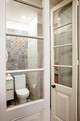 a bathroom with a toilet through a glass door at MeMeraki Artist Residency in Limassol